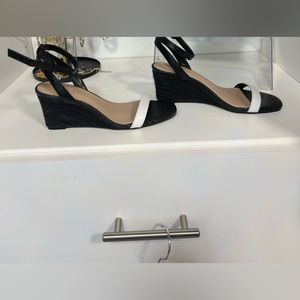 Black and White wedge sandal with ankle strap.
